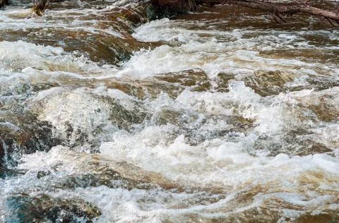 Background, top view, rapid flow river with dark blue water and white foam wa Stock Photos