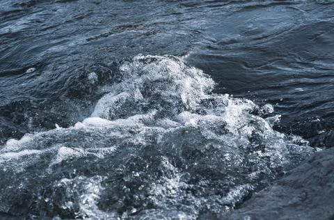 Background, top view, rapid flow river with dark blue water and white foam wa Stock Photos