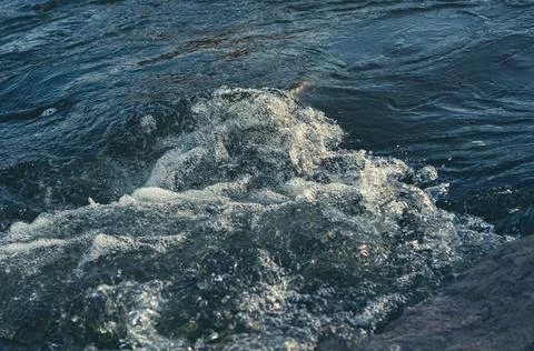 Background, top view, rapid flow river with dark blue water and white foam wa Stock Photos