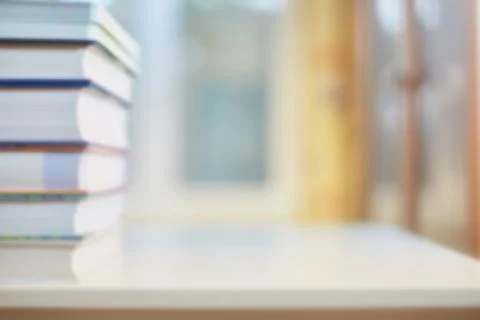 Background on the topic of training, education. Desk with books, bookcase and Stock Photos