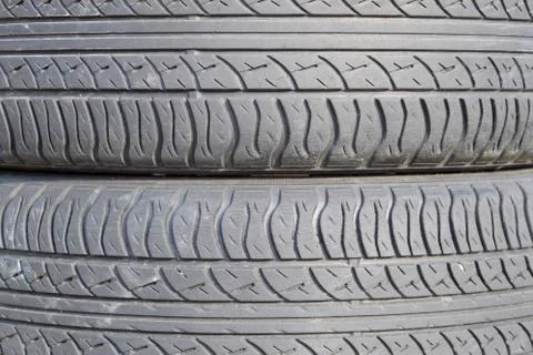 The background of the tread pattern of the car wheel. Rubber tir Stock Photos
