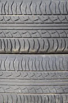 The background of the tread pattern of the car wheel. Rubber tir Stock Photos