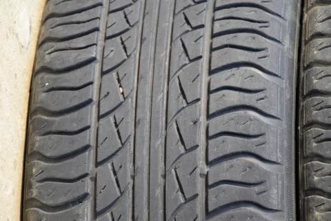 The background of the tread pattern of the car wheel. Rubber tir Stock Photos