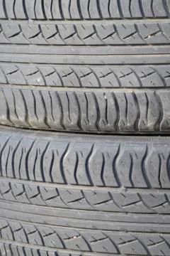 The background of the tread pattern of the car wheel. Rubber tir Stock Photos