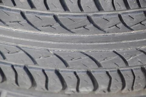 The background of the tread pattern of the car wheel. Rubber tir Stock Photos