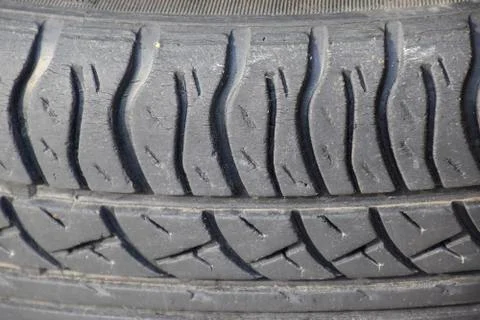 The background of the tread pattern of the car wheel. Rubber tir Stock Photos