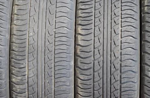 The background of the tread pattern of the car wheel. Rubber tir Stock Photos