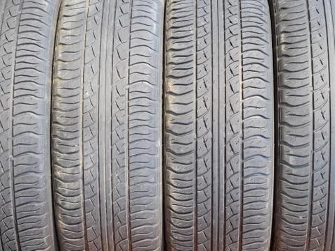 The background of the tread pattern of the car wheel. Rubber tir Stock Photos