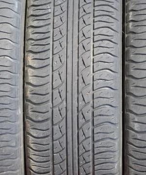 The background of the tread pattern of the car wheel. Rubber tir Stock Photos