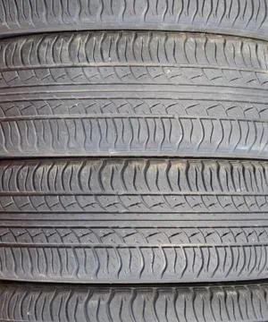 The background of the tread pattern of the car wheel. Rubber tir Stock Photos
