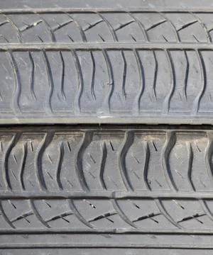 The background of the tread pattern of the car wheel. Rubber tir Stock Photos