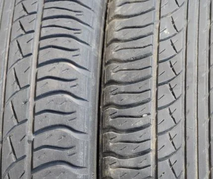The background of the tread pattern of the car wheel. Rubber tir Stock Photos