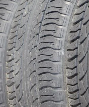 The background of the tread pattern of the car wheel. Rubber tir Stock Photos
