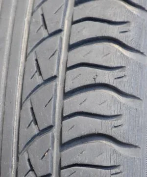 The background of the tread pattern of the car wheel. Rubber tir Stock Photos