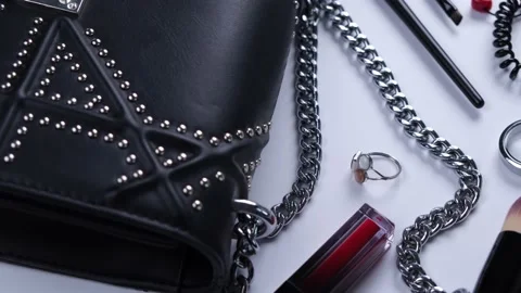 Background with trendy black handbag and decorative cosmetics Stock Footage 213911581