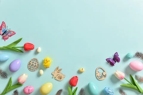 Background with tulips, butterfly, colored Easter eggs and Easter bunnies on  Stock Photos