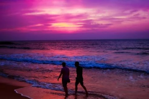 Background Two friends walking through in the beach during a sunset in sri la Fotos de archivo