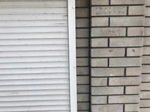 The background is two pieces, left plastic white rollettes on the right wall Stock Photos