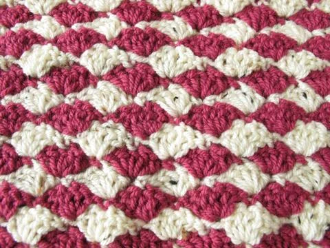 Background of two-toned crocheted shells in berry colors Stock Photos