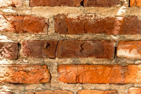 Background of uneven old bricks with shadows Foto stock