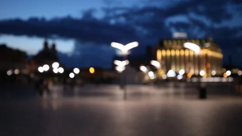 Background of unfocused city lights and people walking at the square Stock Footage 87636664