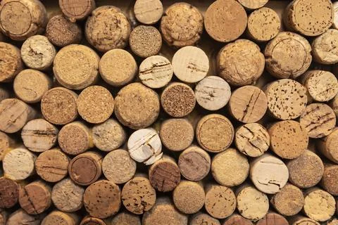 Background of used wine corks in different shapes, colours and sizes. Stock Photos