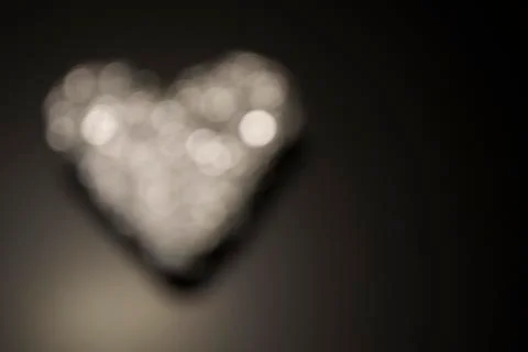 Background for Valentine's day with a luminous heart Stock Photos