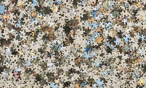 Background from a variety of puzzles on the table. Flat lay. Big pile of puzzles Stock Photos