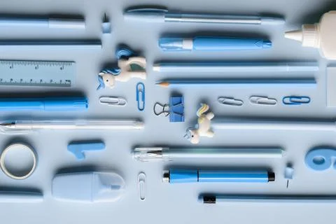 Background with various blue stationery lying diagonally on a light blue back Stock Photos