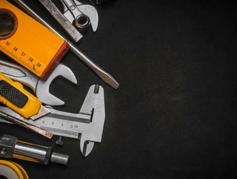 Background of various construction tools. Building tools repair set on black  Stock Photos