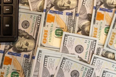 Background of various US dollar banknotes with calculator close up Stock-Fotos