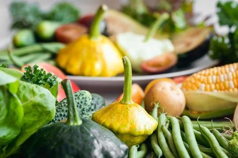 Background of vegetables and herbs on the kitchen table. Stock Photos