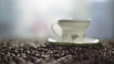 Background video of coffee beans on which a cup of coffee is standing. Stock Footage 238773400