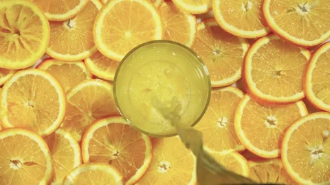 Background video of a composition of fresh oranges and pouring juice Stock Footage 241232471