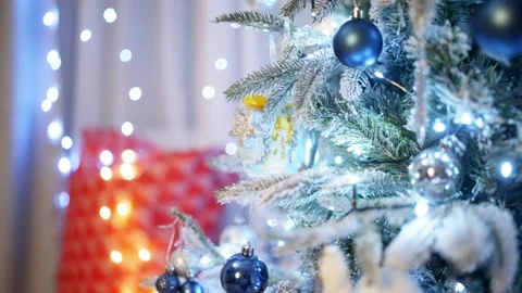 In the background video, a luxurious Christmas tree shines with lights. Stock Footage 258471735