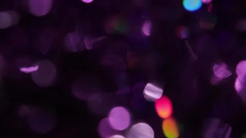 Background video with multi-colored, holographic, and purple bokeh lights overla Stockbeeldmateriaal 318203089