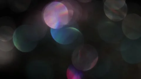 Background video of multicolored bokeh lights glowing in the dark Vídeo Stock 318068343