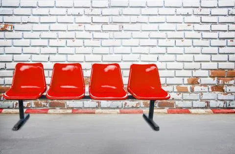 Background view from footpath with red chair old brick wall background and te Stock Photos