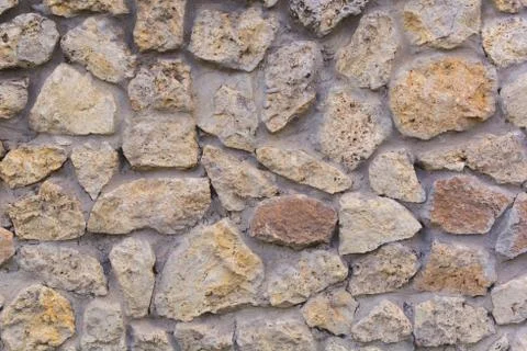 Background. Wall of broken white stone Stock Photos