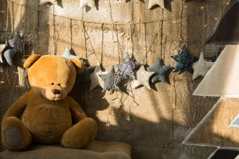 Background wall of burlap with a teddy bear and fir wood. Stock Photos