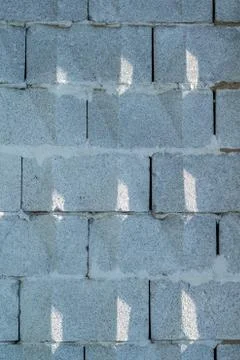 Background, wall of large gray brick blocks with triangular patterns Stock Photos