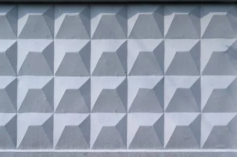 Background, wall of large gray brick blocks with triangular patterns 스톡 사진