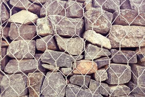 Background wall of large rocks with protection from collapse Stock Photos