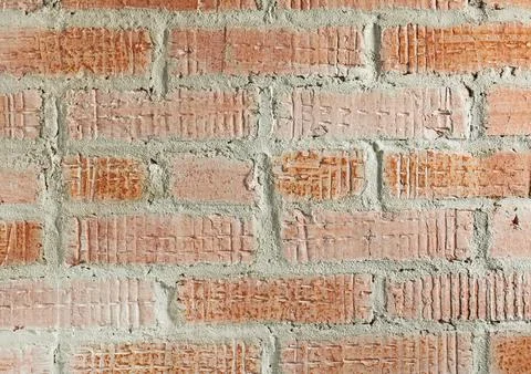 Background from a wall made of bleached brick with rough seams Stock Photos