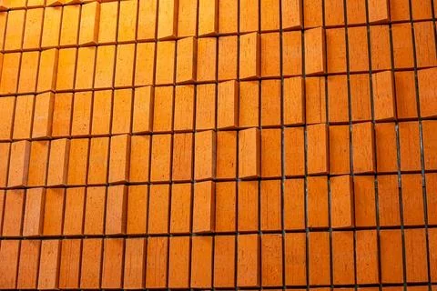The background of the wall is made of vertical rows of brickwork of a brown y Stock Photos