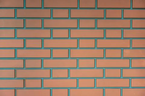 Background wall of modern red bricks fastened with cement Stock Photos