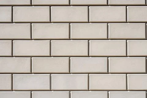 Background of a wall with rectangular beige stone slabs Stock Photos