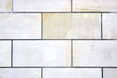 Background of a wall with rectangular white stone slabs Stock Photos