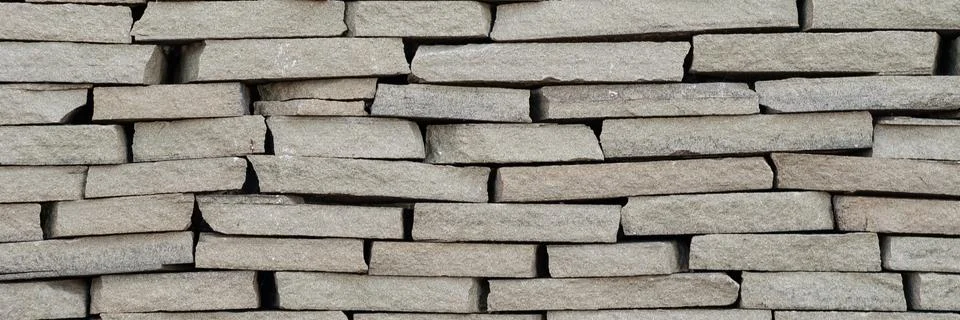 Background wall small light brown textural decorative brick. Stock Photos