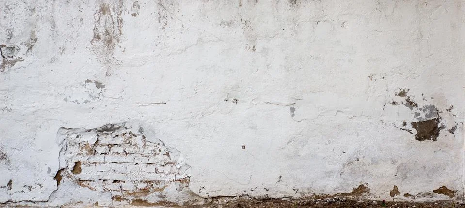 The background is a wall texture with old white plaster that has cracked and  Stock Photos
